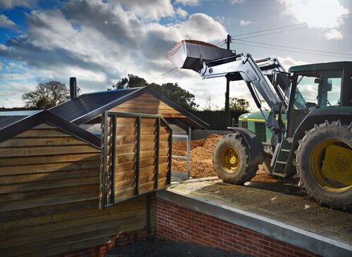 Tractor loading a biomass chip store | © Zero Ridge ltd